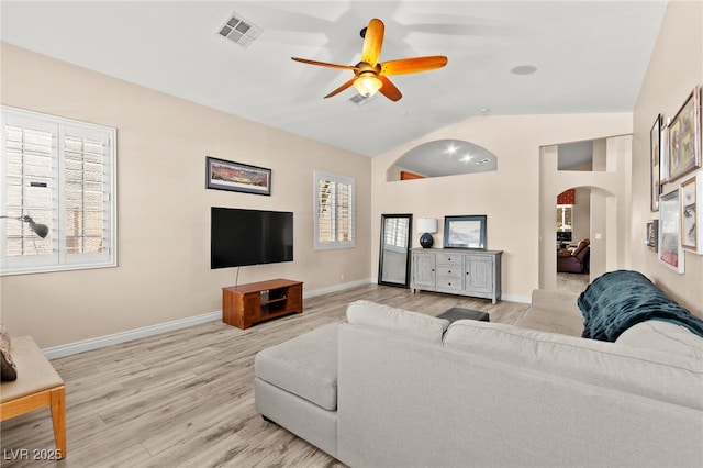 9733 Northern Dancer Dr, Las Vegas, NV 89117 - living room with arched walkways, light wood finished floors, ceiling fan, and high vaulted ceiling