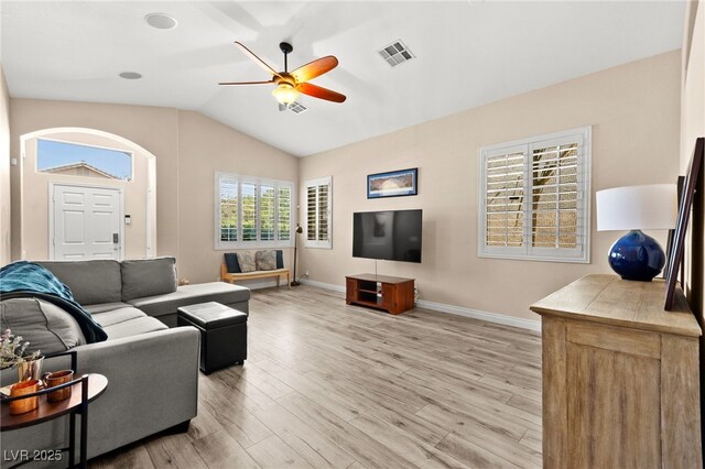 9733 Northern Dancer Dr, Las Vegas, NV 89117 - living area with a ceiling fan, light wood-type flooring, vaulted ceiling, and arched walkways