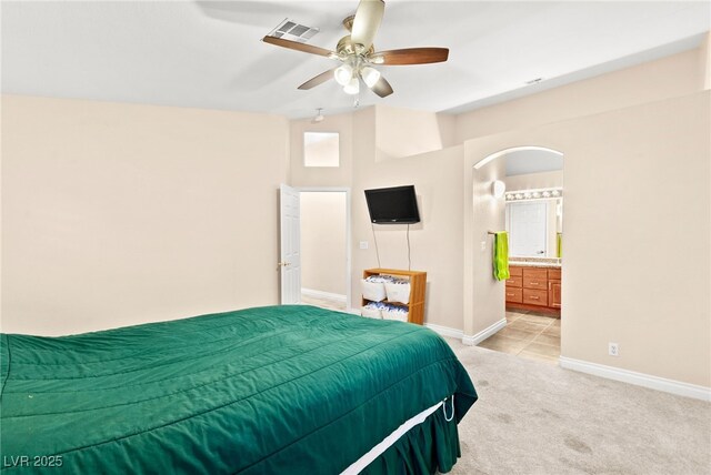 9733 Northern Dancer Dr, Las Vegas, NV 89117 - bedroom featuring light carpet, arched walkways, ensuite bath, and a ceiling fan