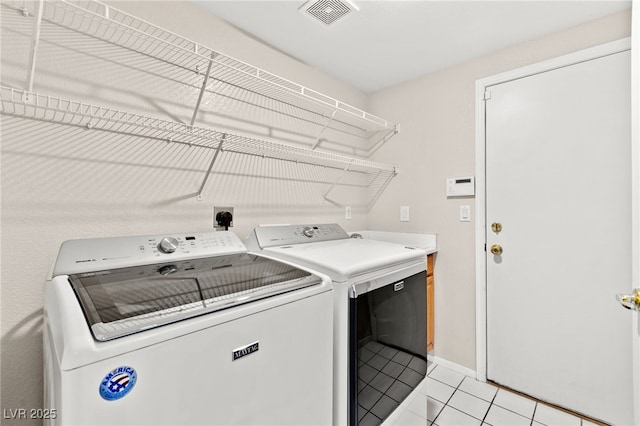 9733 Northern Dancer Dr, Las Vegas, NV 89117 - washroom featuring washing machine and dryer and light tile patterned floors