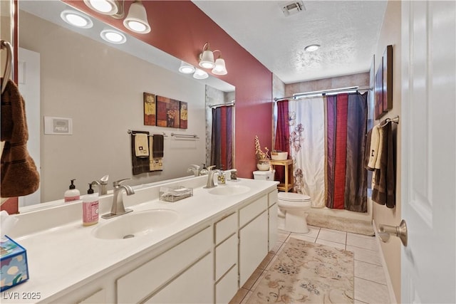 3361 Iberia St, Las Vegas, NV 89146 - bathroom featuring tile patterned flooring, a shower with shower curtain, double vanity, and a textured ceiling