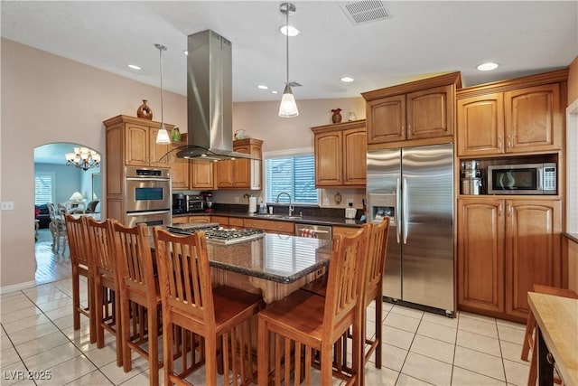 3361 Iberia St, Las Vegas, NV 89146 - kitchen featuring stainless steel appliances, island exhaust hood, light tile patterned floors, a breakfast bar, and recessed lighting