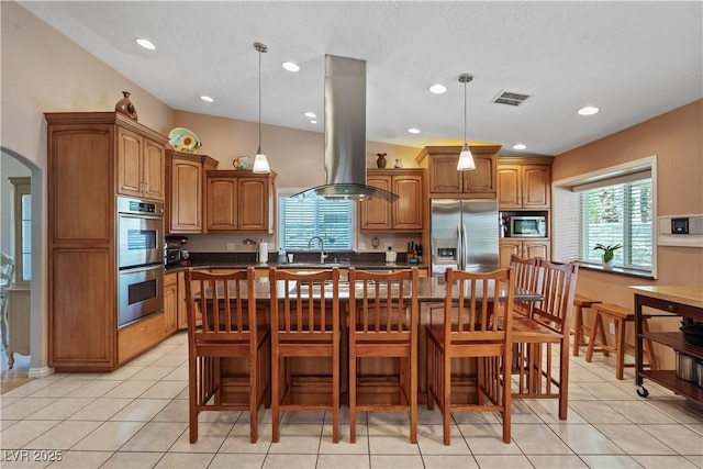 3361 Iberia St, Las Vegas, NV 89146 - kitchen featuring stainless steel appliances, island range hood, brown cabinets, healthy amount of natural light, and recessed lighting