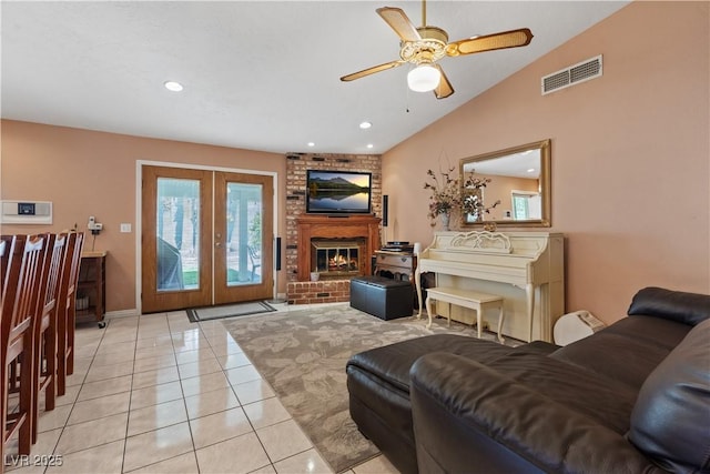 3361 Iberia St, Las Vegas, NV 89146 - living room featuring a ceiling fan, plenty of natural light, light tile patterned floors, a brick fireplace, and lofted ceiling