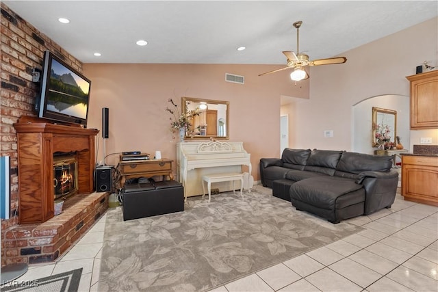 3361 Iberia St, Las Vegas, NV 89146 - living room with light tile patterned floors, a fireplace, a ceiling fan, arched walkways, and recessed lighting