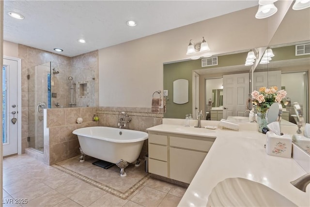 3361 Iberia St, Las Vegas, NV 89146 - bathroom with a stall shower, tile walls, a freestanding tub, vanity, and tile patterned floors