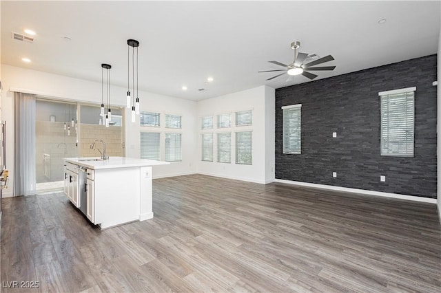901 Allister Fields Ln, Las Vegas, NV 89138 - kitchen featuring open floor plan, a ceiling fan, light countertops, hanging light fixtures, and white cabinetry