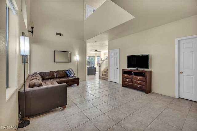 8421 Cheerful Brook Ave, Las Vegas, NV 89143 - living area featuring light tile patterned floors, ceiling fan, and stairs