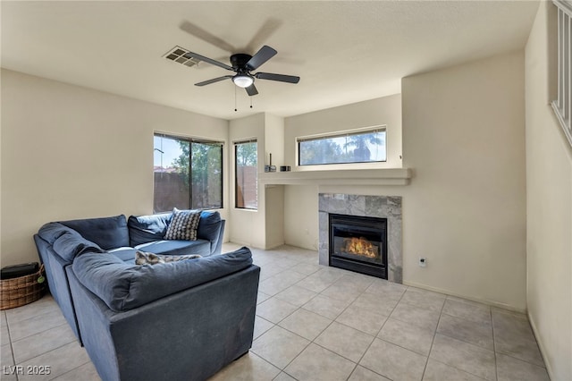 8421 Cheerful Brook Ave, Las Vegas, NV 89143 - living room with a tiled fireplace, a ceiling fan, and light tile patterned floors
