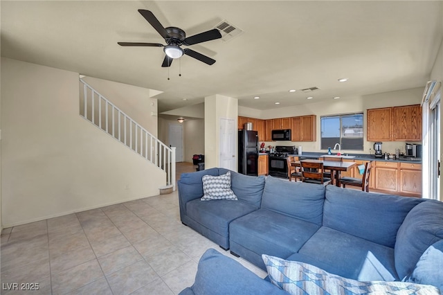 8421 Cheerful Brook Ave, Las Vegas, NV 89143 - living room with stairway, ceiling fan, light tile patterned floors, and recessed lighting