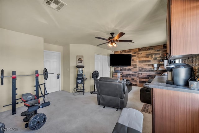 8421 Cheerful Brook Ave, Las Vegas, NV 89143 - living room with a ceiling fan, light carpet, and wooden walls