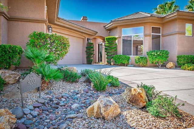 9233 Canyon Mesa Dr, Las Vegas, NV 89144 - entrance to property with driveway, stucco siding, and a garage