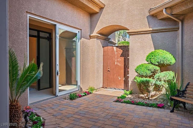 9233 Canyon Mesa Dr, Las Vegas, NV 89144 - property entrance with stucco siding, a gate, and a patio
