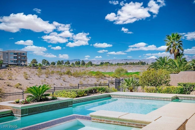 9233 Canyon Mesa Dr, Las Vegas, NV 89144 - view of swimming pool featuring an in-ground hot tub, a fenced backyard, and a mountain view