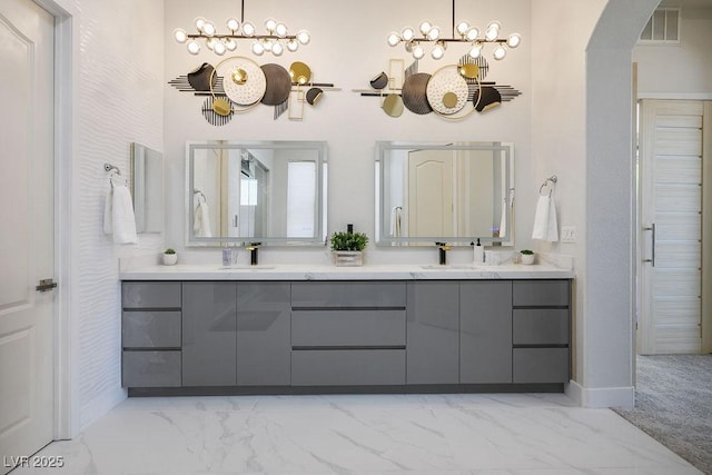 9233 Canyon Mesa Dr, Las Vegas, NV 89144 - full bath featuring marble look tile flooring, double vanity, and a chandelier