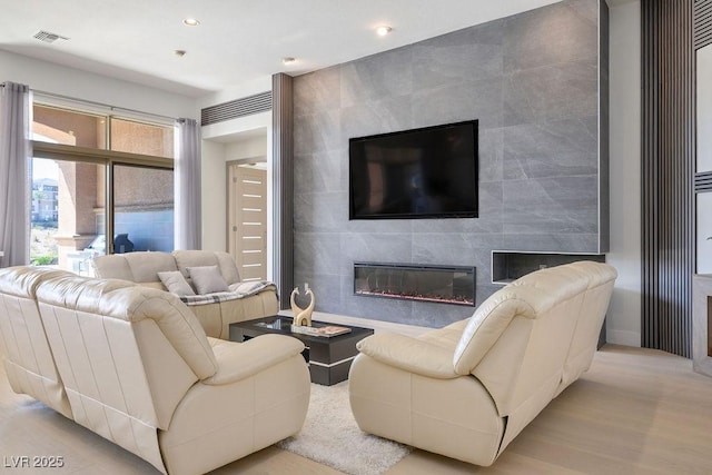 9233 Canyon Mesa Dr, Las Vegas, NV 89144 - living area with a tile fireplace, recessed lighting, and wood finished floors