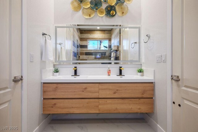 9233 Canyon Mesa Dr, Las Vegas, NV 89144 - full bath with double vanity, marble look tiles, and a textured wall