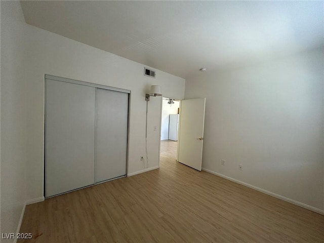 5650 E Sahara Ave Unit 2007, Las Vegas, NV 89142 - unfurnished bedroom with wood finished floors and a closet