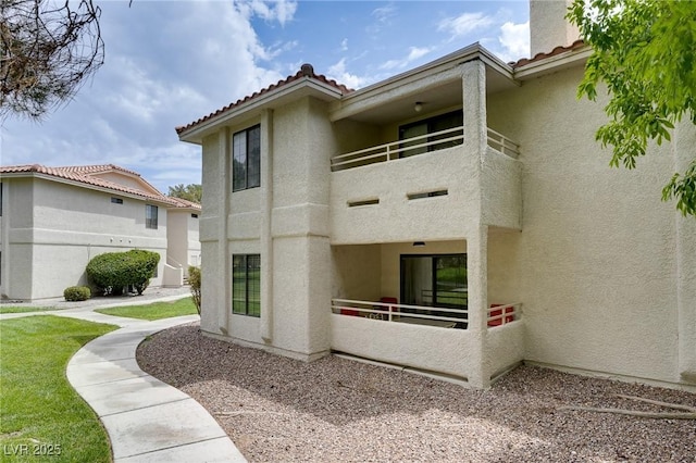 2633 S Durango Dr Unit 202, Las Vegas, NV 89117 - back of property with a balcony, stucco siding, and a tile roof