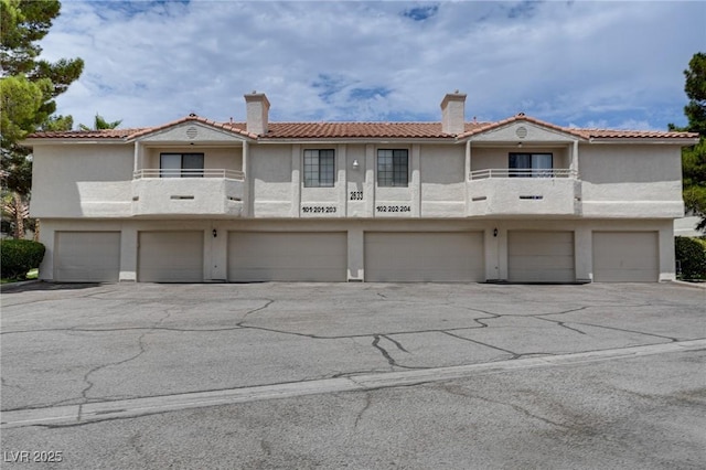2633 S Durango Dr Unit 202, Las Vegas, NV 89117 - townhome / multi-family property featuring a balcony, a garage, and stucco siding