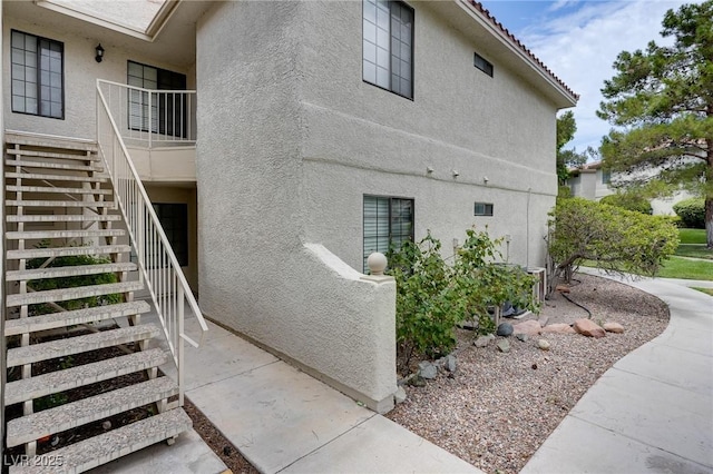 2633 S Durango Dr Unit 202, Las Vegas, NV 89117 - view of side of home with stucco siding and stairway