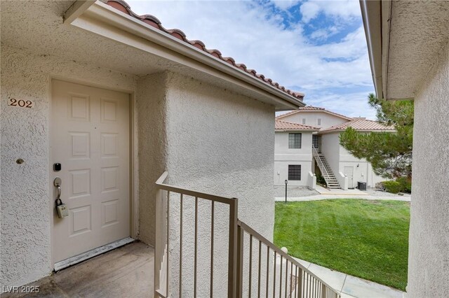 2633 S Durango Dr Unit 202, Las Vegas, NV 89117 - entrance to property with stucco siding, a tiled roof, and a balcony