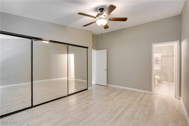 2633 S Durango Dr Unit 202, Las Vegas, NV 89117 - unfurnished bedroom featuring a closet, wood finished floors, ensuite bathroom, and a ceiling fan
