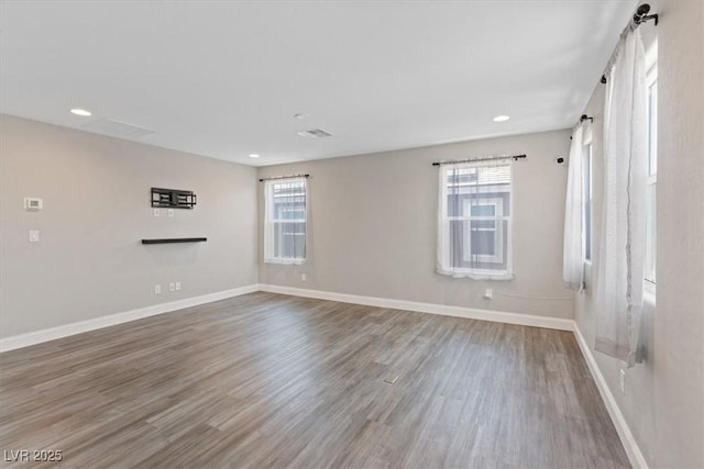 10058 Matter Overlook Dr, Las Vegas, NV 89178 - spare room with healthy amount of natural light, wood finished floors, and recessed lighting