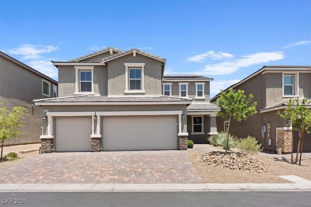 10058 Matter Overlook Dr, Las Vegas, NV 89178 - view of front facade featuring a garage, stucco siding, driveway, and stone siding