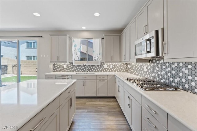 10058 Matter Overlook Dr, Las Vegas, NV 89178 - kitchen featuring appliances with stainless steel finishes, light countertops, recessed lighting, backsplash, and light wood-style flooring