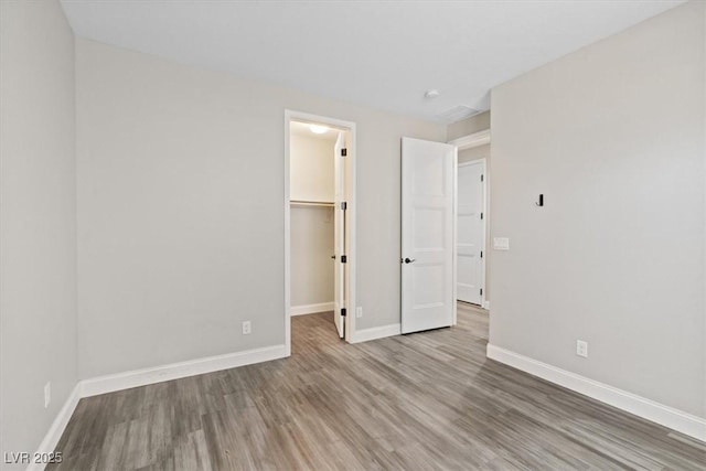 10058 Matter Overlook Dr, Las Vegas, NV 89178 - unfurnished bedroom with wood finished floors, a spacious closet, and a closet