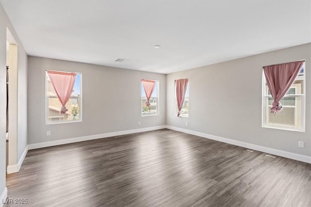 10058 Matter Overlook Dr, Las Vegas, NV 89178 - spare room featuring plenty of natural light and dark wood finished floors