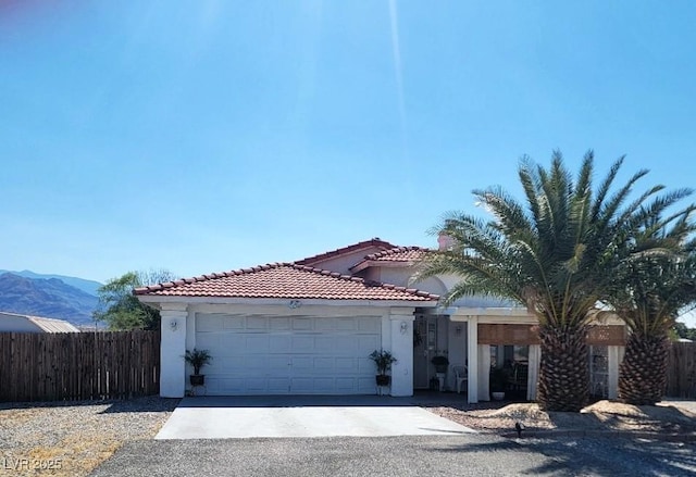 2801 Peggy Ave, Pahrump, NV 89048 - view of front facade with an attached garage, stucco siding, driveway, and a tile roof