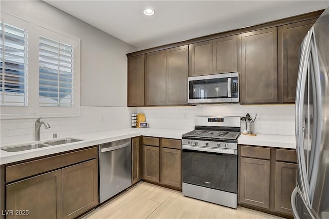 1113 Fragrant Cactus Ct, North Las Vegas, NV 89031 - kitchen featuring stainless steel appliances, backsplash, light countertops, recessed lighting, and dark brown cabinetry