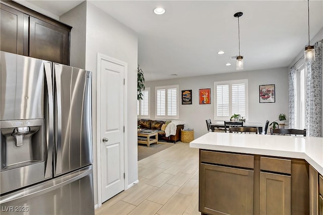 1113 Fragrant Cactus Ct, North Las Vegas, NV 89031 - kitchen featuring stainless steel refrigerator with ice dispenser, light countertops, recessed lighting, hanging light fixtures, and a peninsula