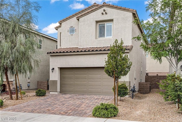 1113 Fragrant Cactus Ct, North Las Vegas, NV 89031 - mediterranean / spanish-style home featuring decorative driveway, a tile roof, stucco siding, and a garage