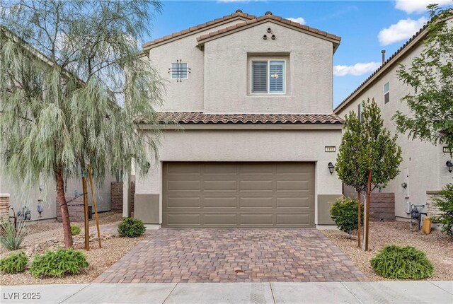 1113 Fragrant Cactus Ct, North Las Vegas, NV 89031 - mediterranean / spanish-style home featuring a tiled roof, stucco siding, decorative driveway, and an attached garage
