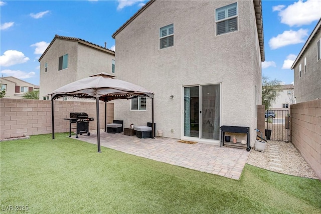 1113 Fragrant Cactus Ct, North Las Vegas, NV 89031 - back of property featuring stucco siding, a gazebo, a fenced backyard, and a gate