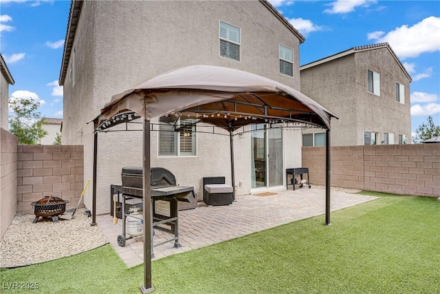 1113 Fragrant Cactus Ct, North Las Vegas, NV 89031 - back of property with a gazebo, an outdoor fire pit, stucco siding, and a fenced backyard