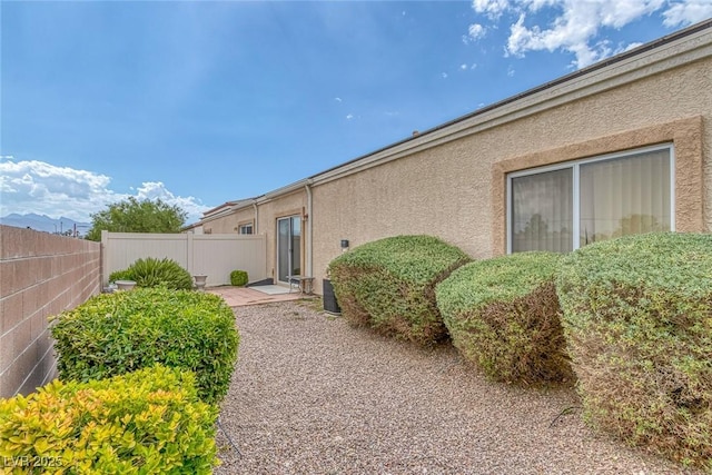 4713 Guma Way N, Las Vegas, NV 89031 - view of exterior entry featuring stucco siding and a patio area