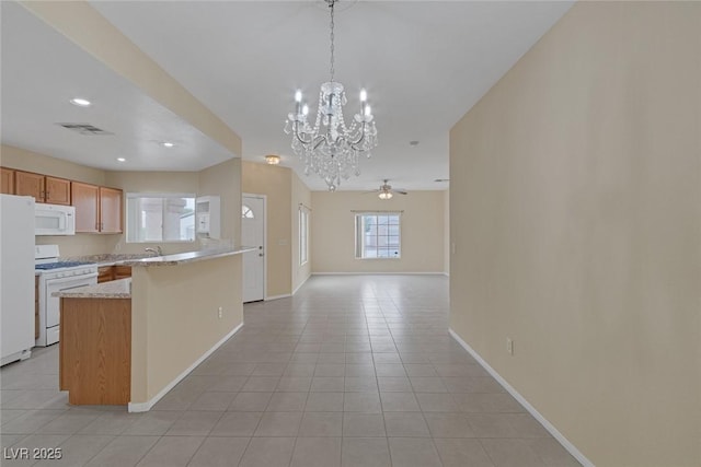 4713 Guma Way N, Las Vegas, NV 89031 - kitchen with white appliances, a ceiling fan, a chandelier, light tile patterned floors, and recessed lighting