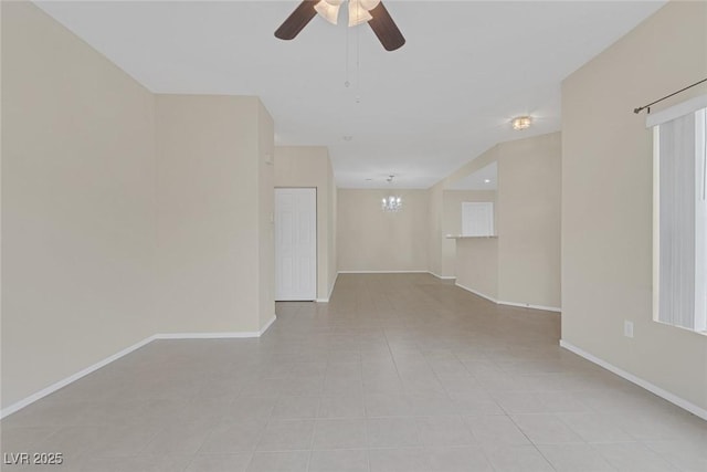 4713 Guma Way N, Las Vegas, NV 89031 - spare room with light tile patterned floors, ceiling fan, and a chandelier