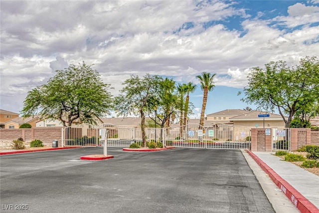 4713 Guma Way N, Las Vegas, NV 89031 - view of asphalt street featuring sidewalks, a gate, curbs, and a gated entry