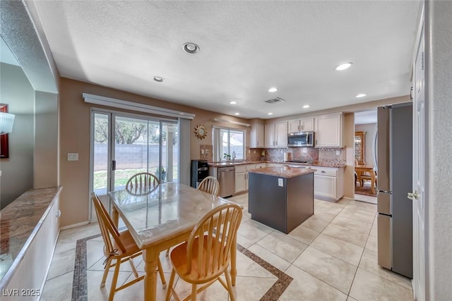 8914 Termoli St, Las Vegas, NV 89123 - dining room with inlaid floor details, recessed lighting, light tile patterned floors, and a textured ceiling
