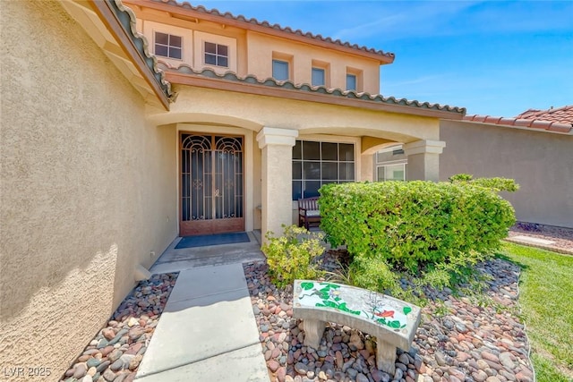 8914 Termoli St, Las Vegas, NV 89123 - view of exterior entry featuring stucco siding and a tile roof