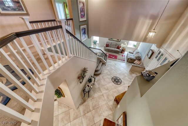 8914 Termoli St, Las Vegas, NV 89123 - stairway with tile patterned flooring and a high ceiling