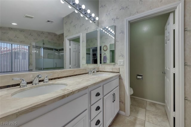 8914 Termoli St, Las Vegas, NV 89123 - full bath featuring double vanity, a shower stall, tile patterned floors, and wallpapered walls