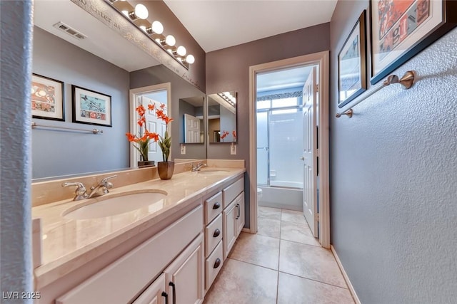 8914 Termoli St, Las Vegas, NV 89123 - full bathroom featuring double vanity, tile patterned flooring, shower / bath combination with glass door, and a textured wall