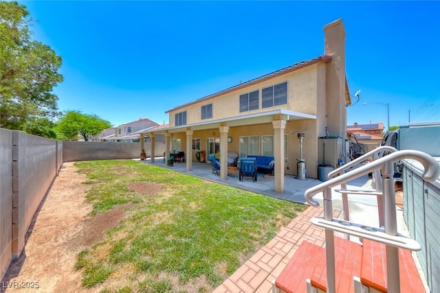8914 Termoli St, Las Vegas, NV 89123 - rear view of house with a patio area, a fenced backyard, stucco siding, a chimney, and an outdoor living space
