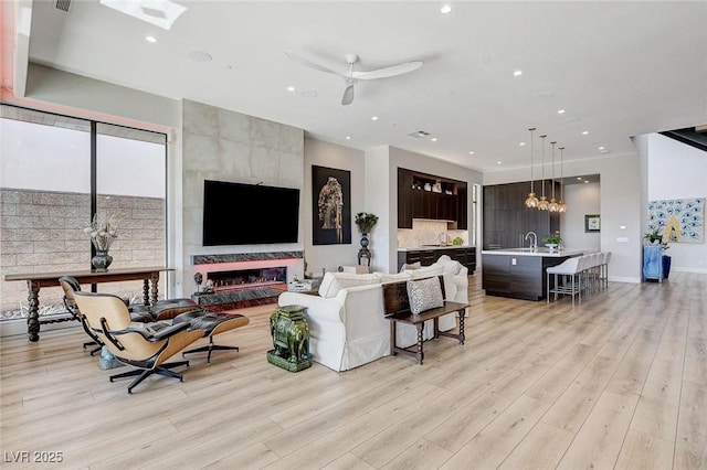 527 Serenity Point Dr, Henderson, NV 89012 - living room with light wood-type flooring, recessed lighting, and a ceiling fan